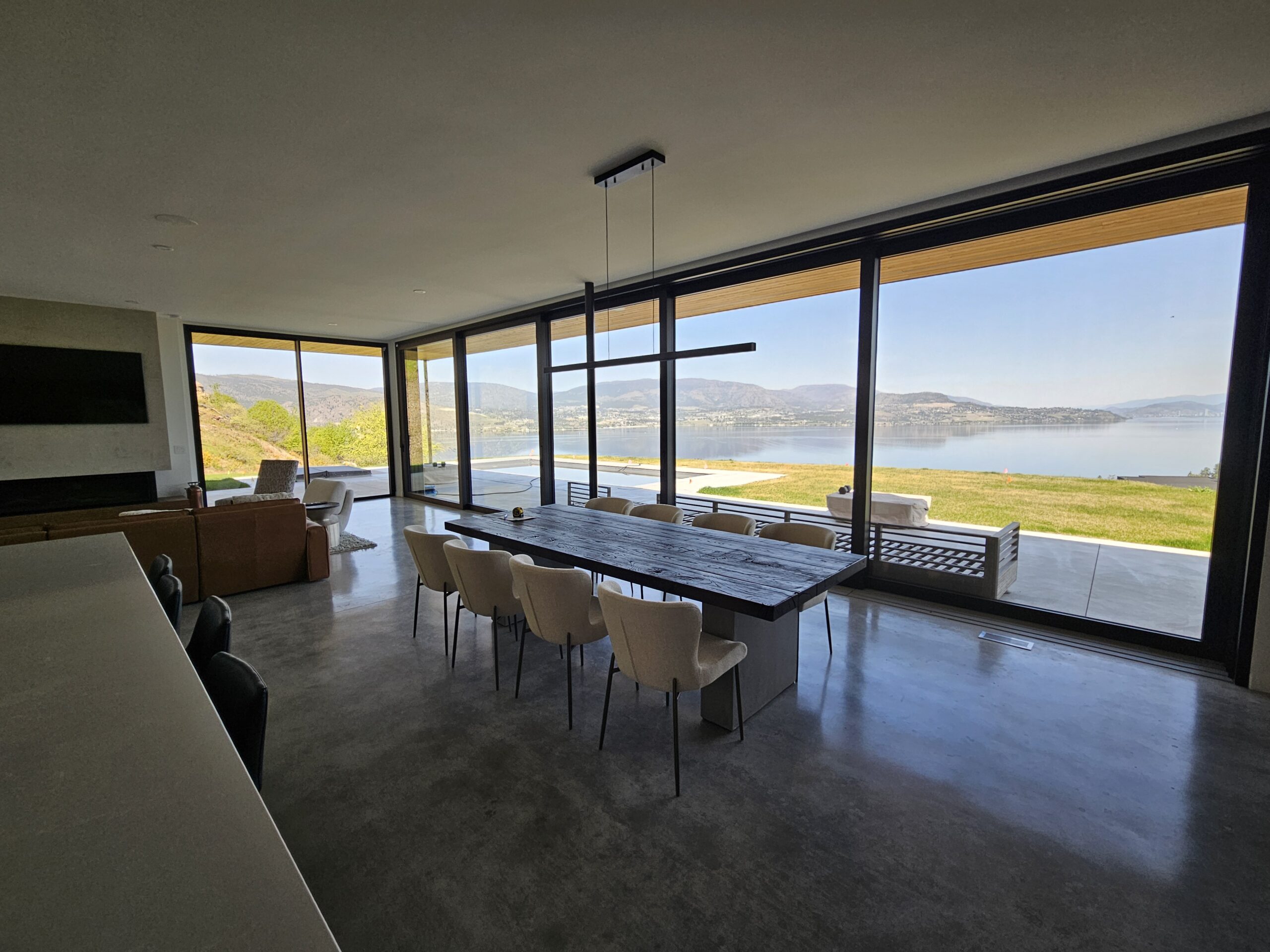 Modern Lake Country home with large lake-view windows wired by Pfitztech electricians