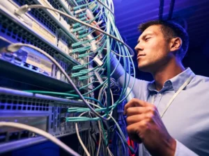 Pfitztech technician installing fiber optic cabling for a Kelowna business network